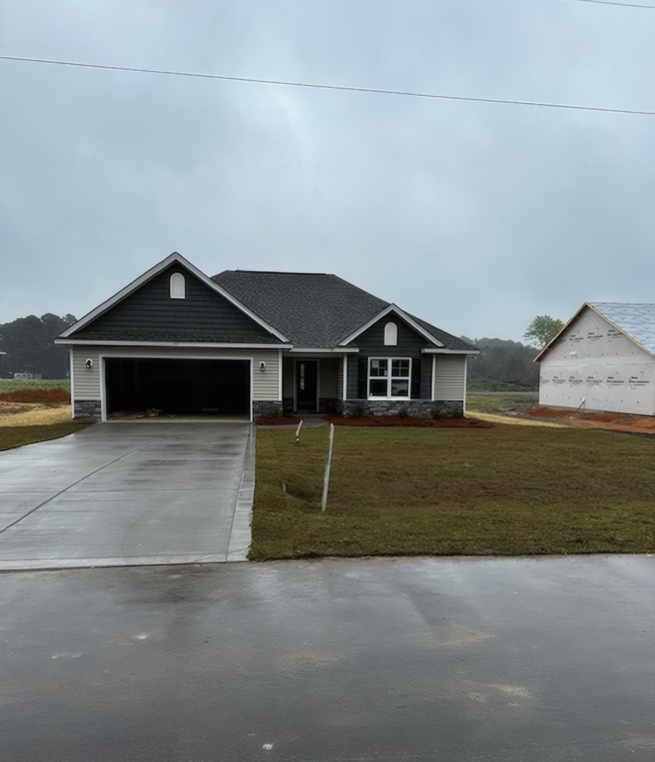 Distance view of grey and tan house with marble pattern on the bottom, the garage is open